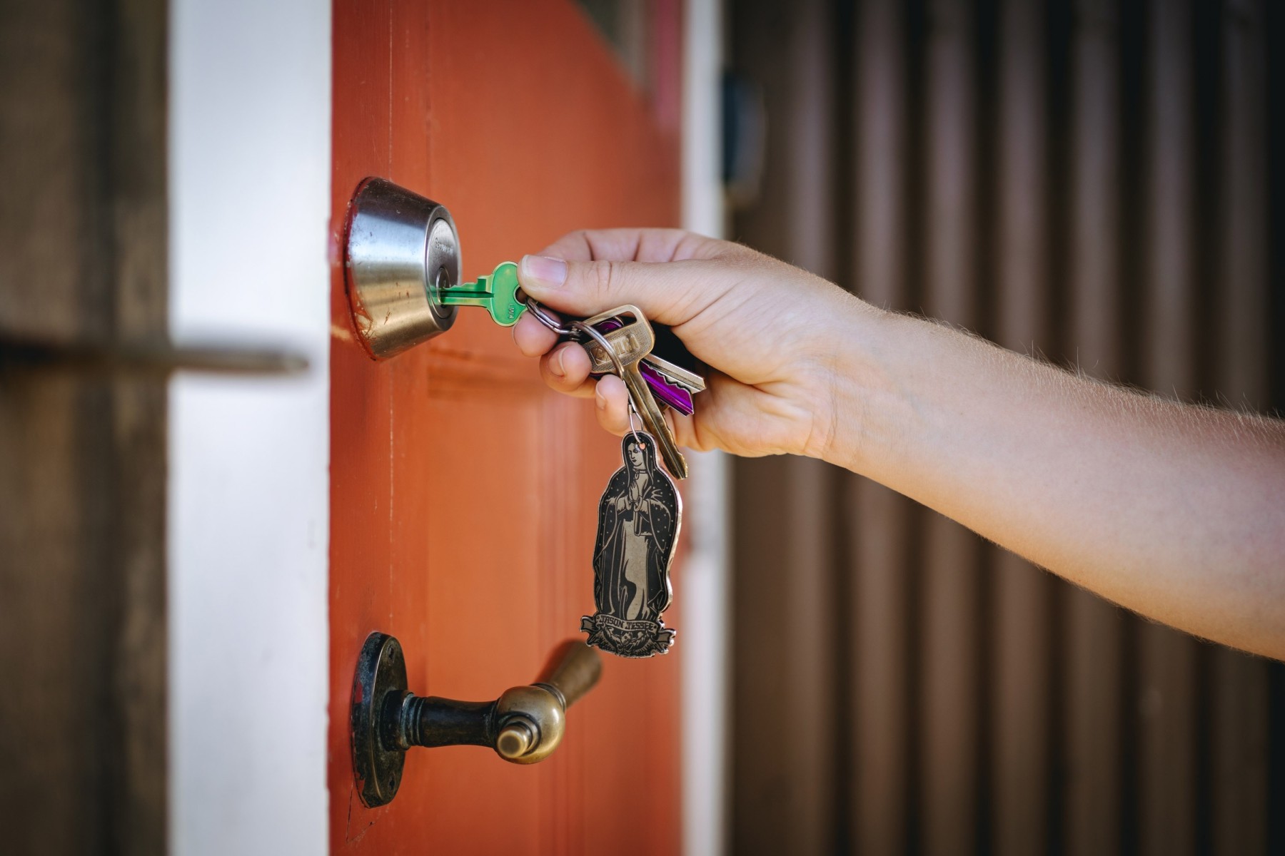 Man opening door to her first home in Queensland
