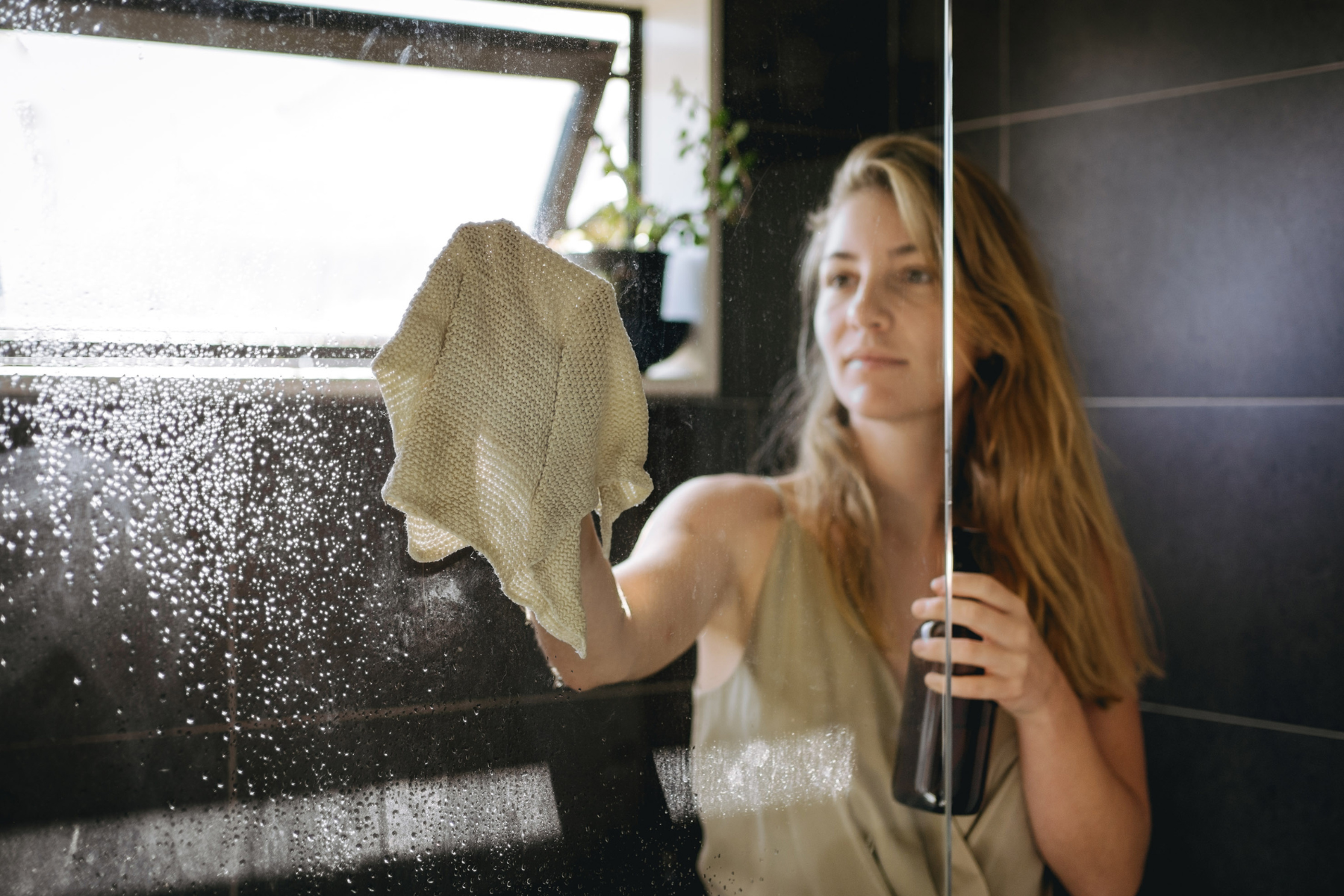 woman cleaning glass