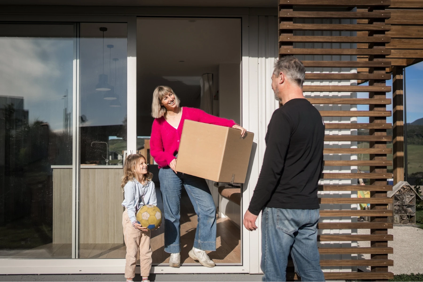 woman with box, child and removalist