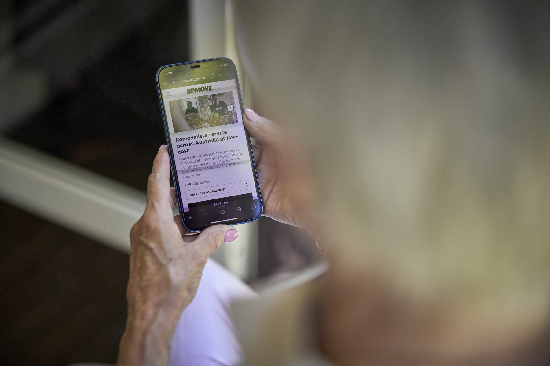 woman looking at removalist website on smartphone