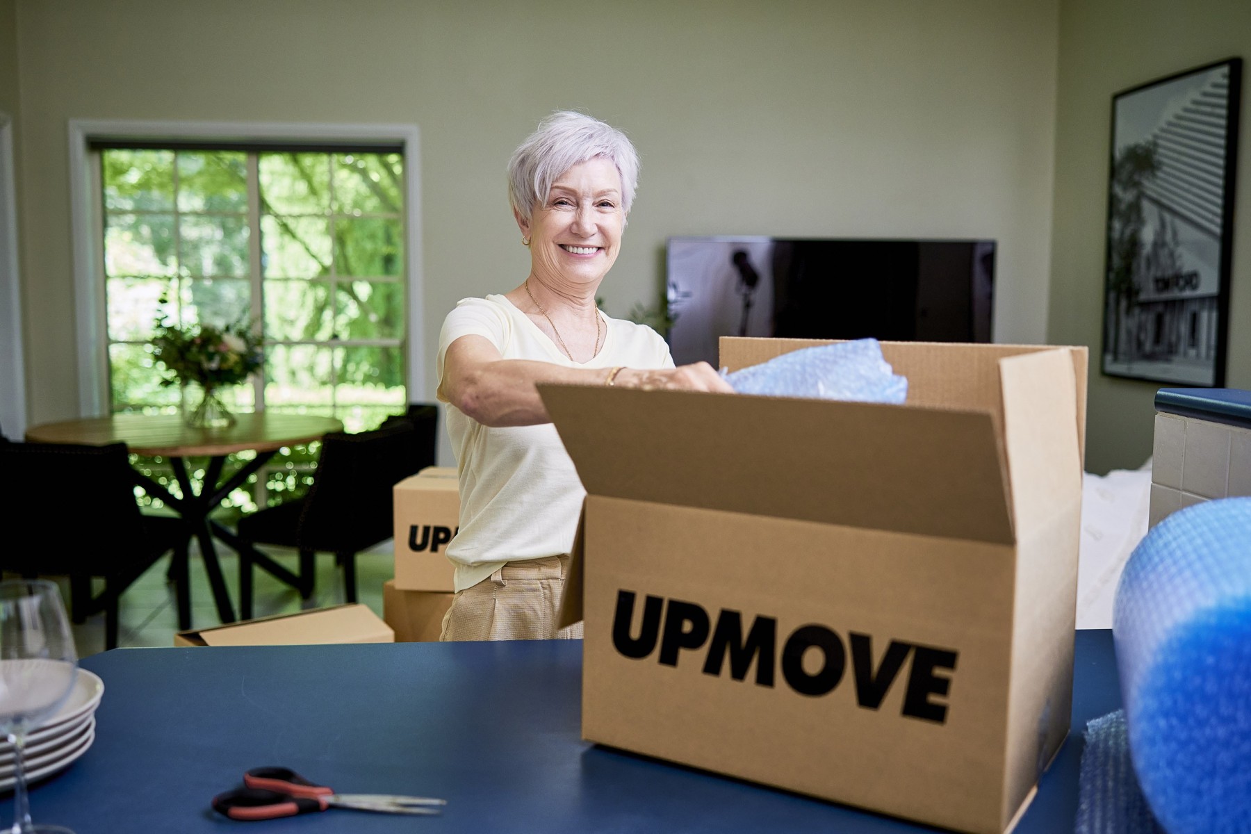 Woman decluttering and downsizing for move to retirement village in Sydney